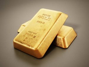 1 kg gold ingots standing on gray background with soft shadows.